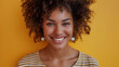 © Ryu - A woman with curly hair is smiling and looking at the camera.