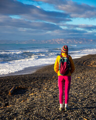 Wall Mural - colorful girl enjoys a sunset at rarangi beach, new zealand south island, marlborough region