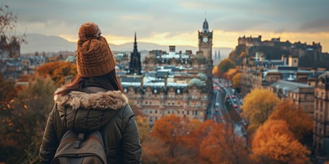 Korean woman admiring the view from a hilltop in Edinburgh, autumn landscape stretching below, [scenic view], [fall adventure]