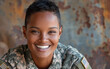 © imagineRbc - A smiling young adult of mixed race, with short black hair, wearing a military uniform and an American flag patch, stands in front of a rustic background