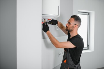 Aufkleber - Professional plumber checking a boiler and pipes, boiler service concept