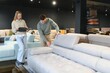 © Serhii - Happy couple choosing furniture in store