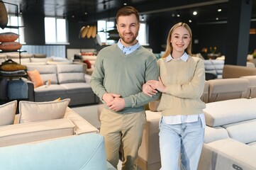 Wall Mural - Couple choosing sofa and pillows at furniture store