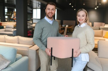 Wall Mural - couple chooses chairs for the home in a store.