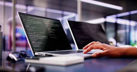 Multi-tasking African American Woman Coding Website on Laptop at Office Desk