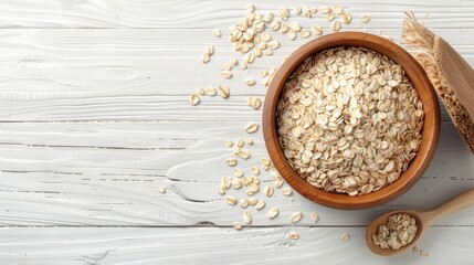 Rolled Oats in Wooden Bowl on White Wood.