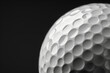© GustavsMD - Close-up view of a golf ball surface with dimples on a black background. Macro photography. Golf equipment and sports concept