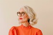 © World of AI - sophisticated older woman with blonde hair and glasses, wearing a stylish orange top and large geometric earrings, looking to the side with a thoughtful expression