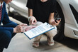 © NINENII - Insurance concept, insurance agent checking broken car and submit a claim form after an accident traffic accident