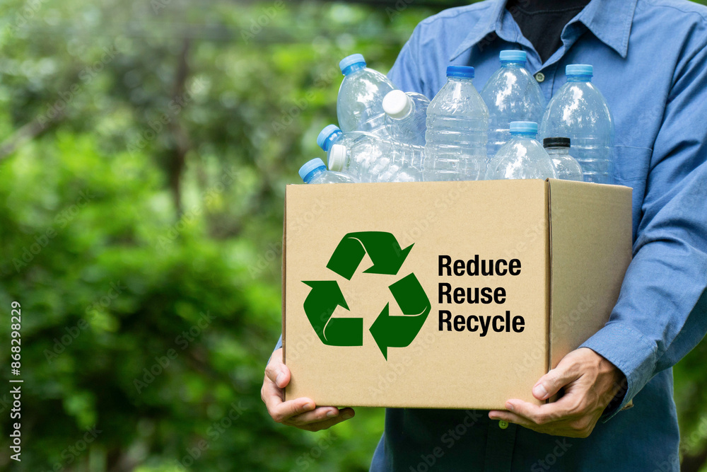 Volunteer holding paper box with Reduce, Reuse, Recycle symbol. World ...