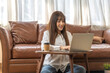 © Art_Photo - Young smiling asian woman relax using laptop conference work,learning education,study online,webinar podcast,creative woman looking at screen, shopping, online marketing at home