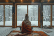 © Miha - A person sits wrapped in a blanket, looking out at a snowy forest through large windows. The cozy interior of the cabin contrasts with the cold, wintry scene outside