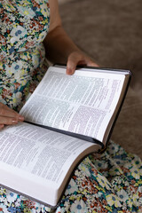 Wall Mural - Senior Christian woman reading holy bible book at home. Close-up. Biblical concept of studying Scriptures. Selective focus.