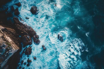 Poster - majestic aerial view of rugged coastline with crashing blue ocean waves on rocky shore abstract photo