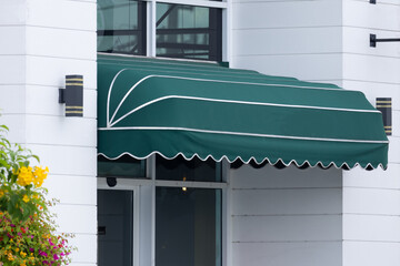 Poster - A green awning with white trim is covering the entrance to a building