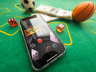 Wall Mural - online casino smartphone with poker chips device over green table