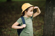 © zulfiska - Cute little girl wear scout uniform standing in a forest. Young kid exploring nature. Outdoor activity for children.