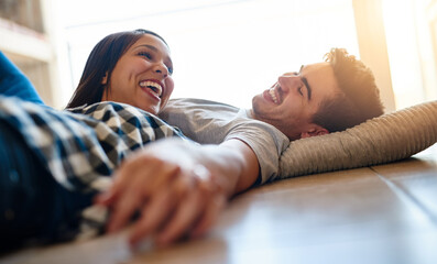 Sticker - Couple, talking and relax on floor of home, love and laughing for funny conversation in apartment. Happy people, speaking and laying on ground of living room, support and comedy in relationship