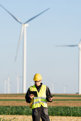 Aufkleber - Engineer with digital tablet works on a field of wind turbines	