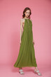 © SBekhinov - High fashion photo of a beautiful elegant young skinny woman in pretty long green dress posing on pink background. Slim figure.