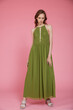 © SBekhinov - High fashion photo of a beautiful elegant young skinny woman in pretty long green dress posing on pink background. Slim figure.