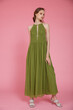 © SBekhinov - High fashion photo of a beautiful elegant young skinny woman in pretty long green dress posing on pink background. Slim figure.