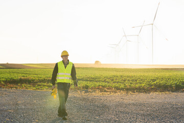 Aufkleber - Engineer with digital tablet works on a field of wind turbines	