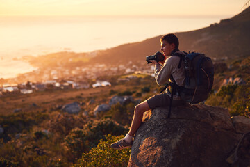 Backpack, hiking and photography with man in mountains for adventure, hobby or travel outdoor. Break, scenic and view with confident hiker or photographer in nature for getaway, holiday or vacation