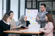 © Witoon - Professional team at and both male and female members participated in a lively brainstorming session at the company office. They collaborate on creative projects using modern technology.