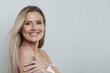 © artmim - Healthy mid adult woman touching her perfect skin. Beautiful portrait mature 50s aged woman on white background.