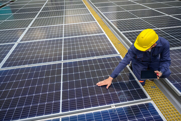 a power plant engineer installs solar panels to inspect the solar panels, engineers use tablets tech