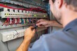 © Chopang.studio - Electrician working on a circuit breaker panel, maintaining and wiring electrical components for consistent and safe power distribution.