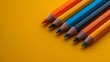 © ART IS AN EXPLOSION. - A row of pencils with different colors on a yellow background