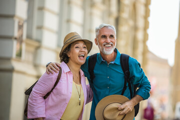 Sticker - Elderly married couple holding their hands in the city center that they are exploring