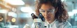 © Pavel - Female scientist working in laboratory using microscope, panoramic banner with copy space area for your text or message.