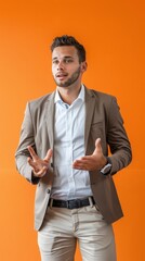 Wall Mural - young businessman giving presentation against an orange back drop