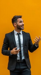 Wall Mural - young businessman giving presentation against an orange back drop