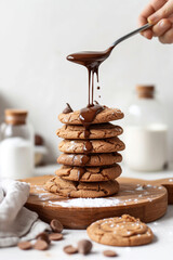 Wall Mural - A stack of chocolate cookies being poured by a melted chocolate