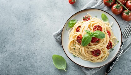 Wall Mural - a dish of spaghetti topped with ripe red tomatoes and fragrant basil leaves with an appealing copy space image