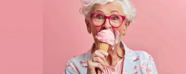 A woman in glasses is holding a pink ice cream cone. She is smiling and she is happy. Free copy space for text.