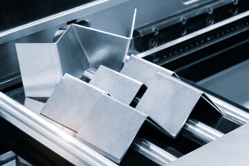 Poster - Metal products bent on a bending machine. Factory made products. Industrial concept background.