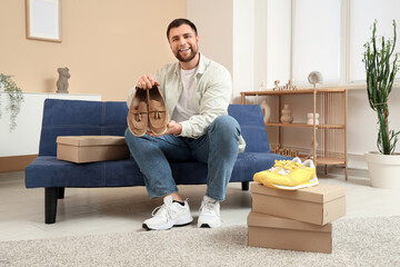 Wall Mural - Happy young man with new stylish shoes at home