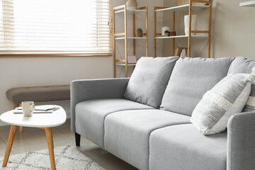 Sticker - Interior of stylish living room with sofa, table and shelf units