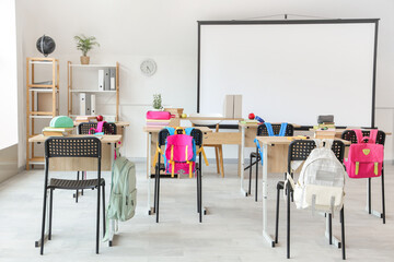 Poster - Interior of light classroom with projector screen and desks