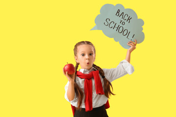 Sticker - Shocked little girl holding speech bubble with text BACK TO SCHOOL and apple on yellow background