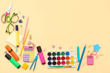 Wall Mural - School supplies with scissors, eyeglasses and palette on beige background. Top view