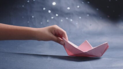 Wall Mural - A small red paper boat is sitting on a water surface