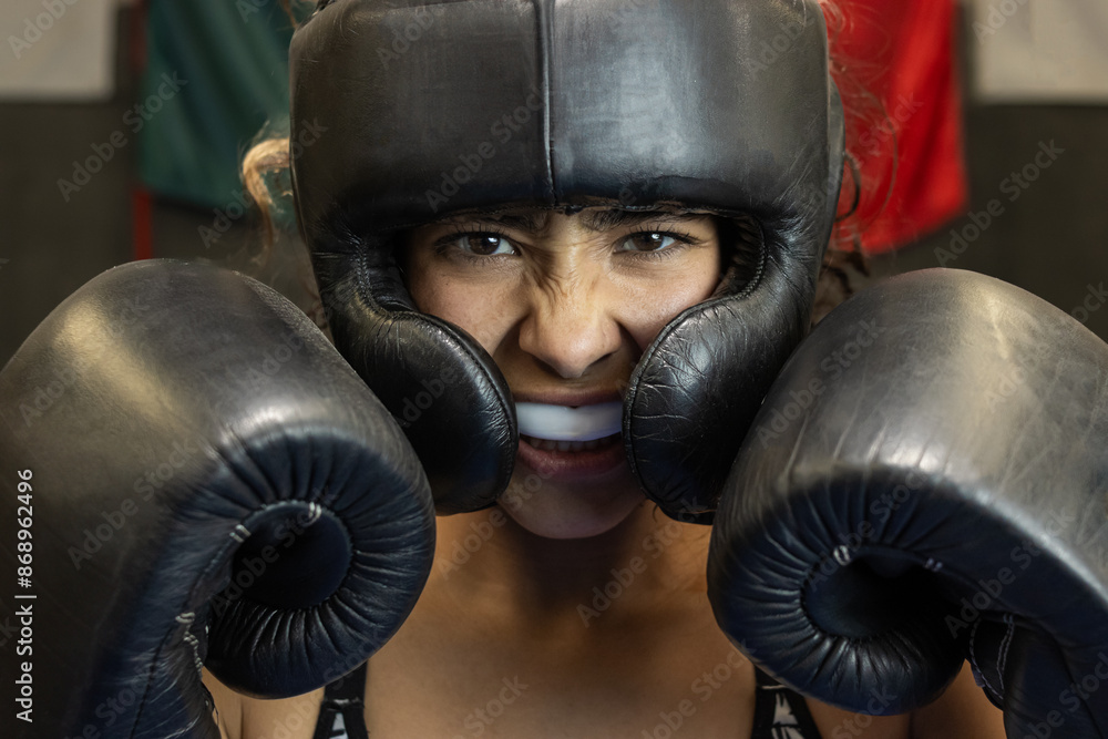 closeup of angry female boxer trained and using mouth guard and face ...
