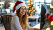 © Keitma - Holidays at work with a business woman celebrating Christmas at office with a red Christmas Santa hat