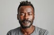 © senyumanmu - portrait of adult Black man looking at camera in studio